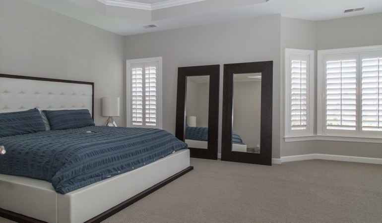 Polywood shutters in a minimalist bedroom in Cleveland.